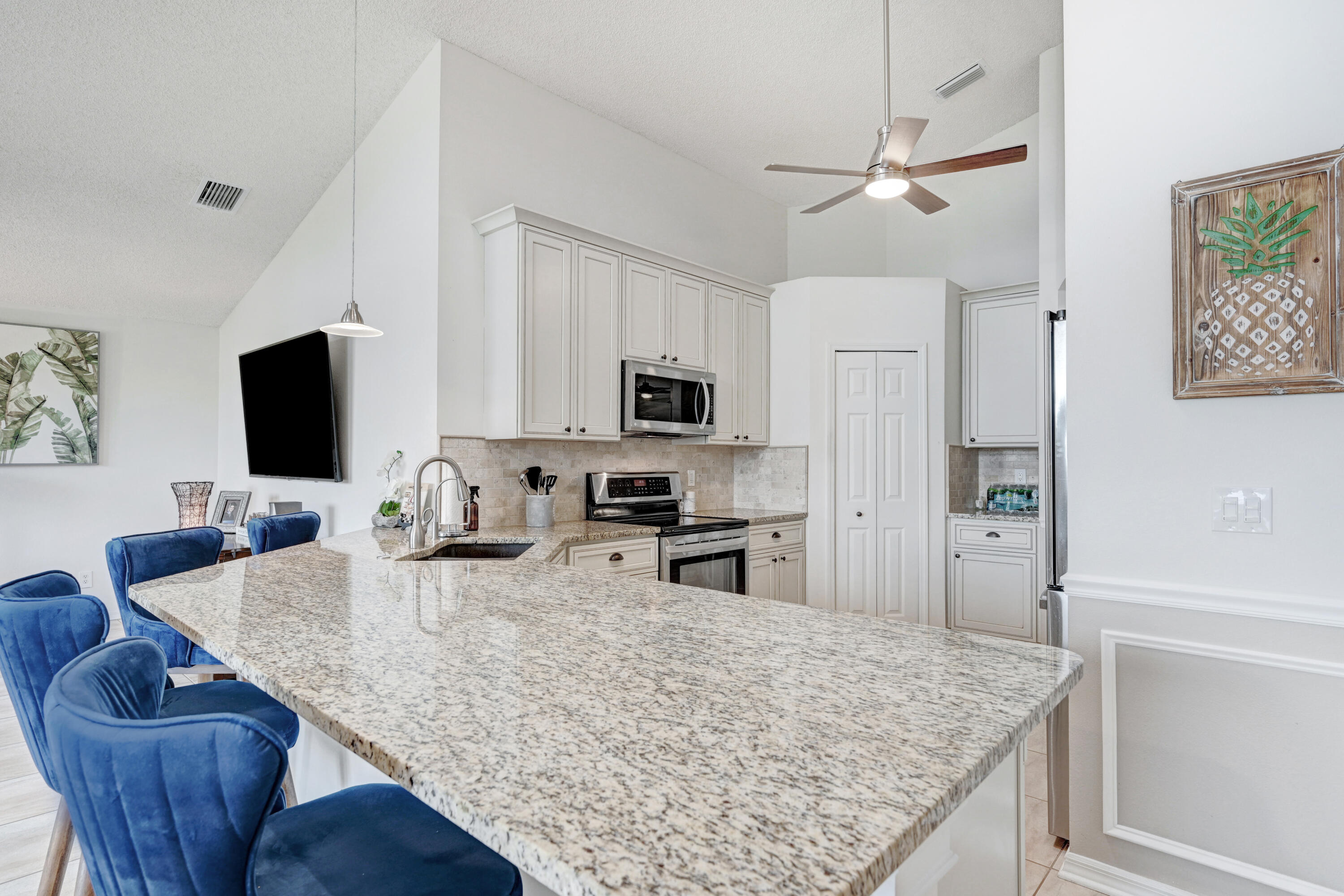 897 Shaw Circle Melbourne, FL 32940 - Photo 27 of 57 a kitchen with stainless steel appliances granite countertop a sink dishwasher stove and refrigerator with wooden floor