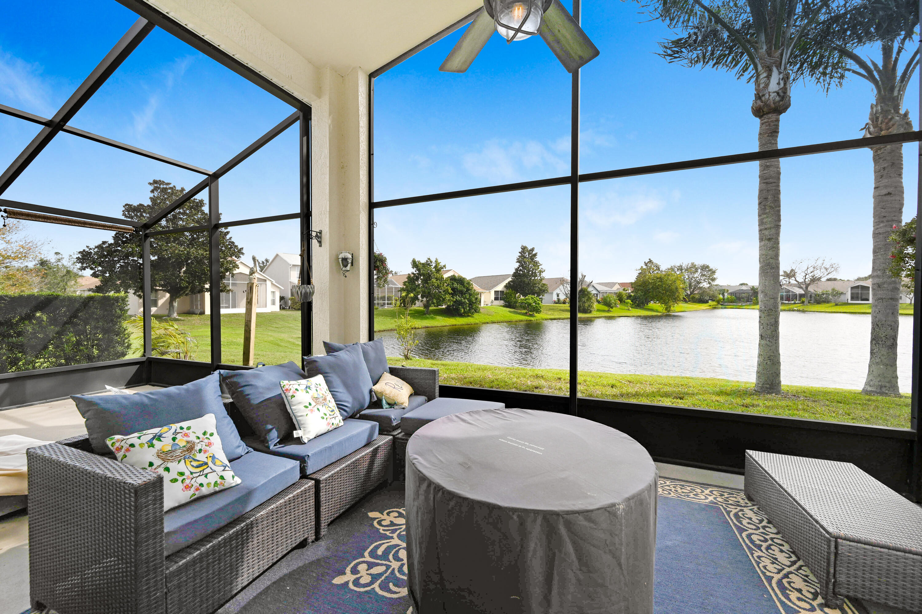 897 Shaw Circle Melbourne, FL 32940 - Photo 30 of 57 a living room with furniture and a floor to ceiling window