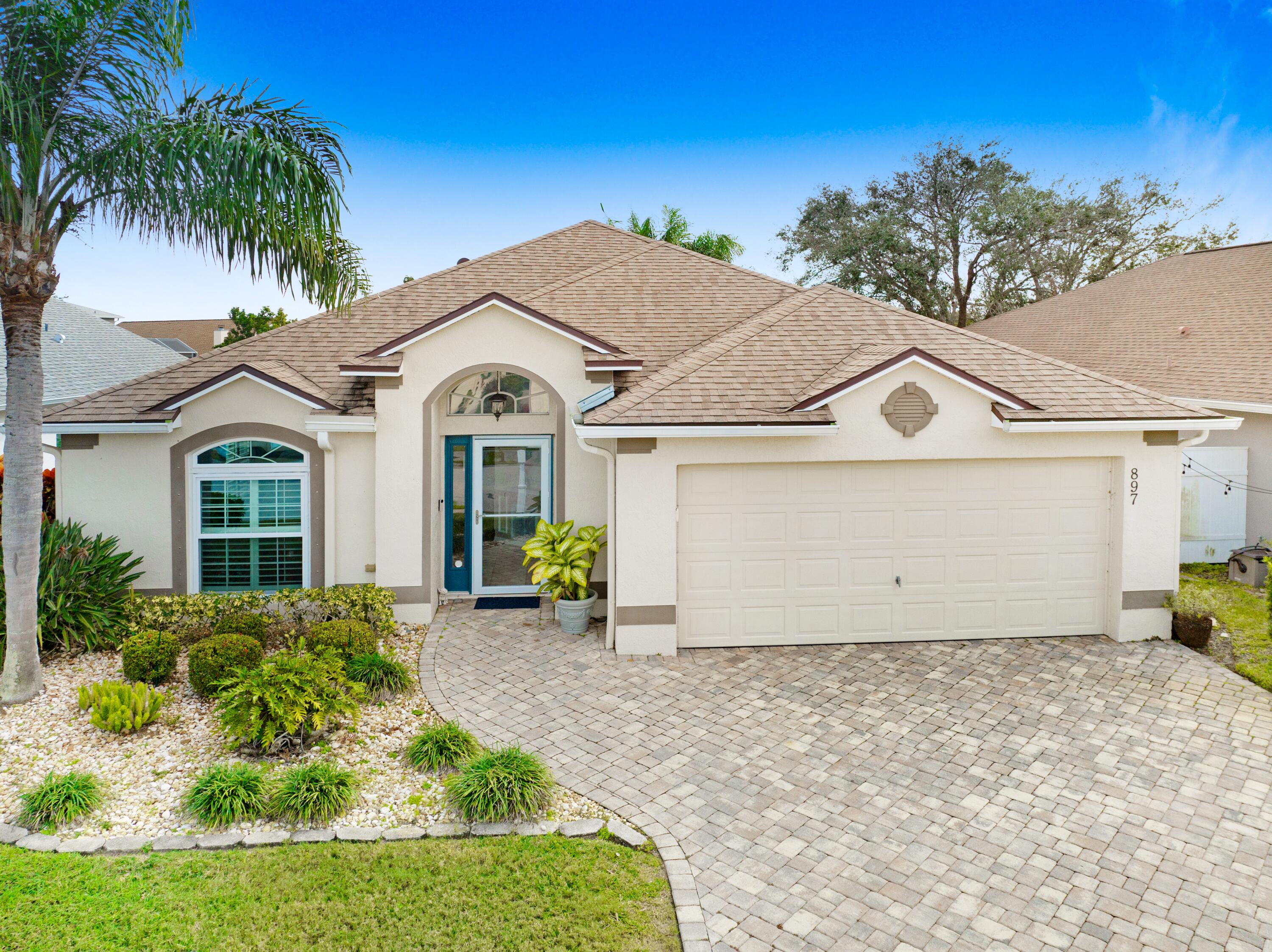 897 Shaw Circle Melbourne, FL 32940 - Photo 3 of 57 a front view of a house with a garden