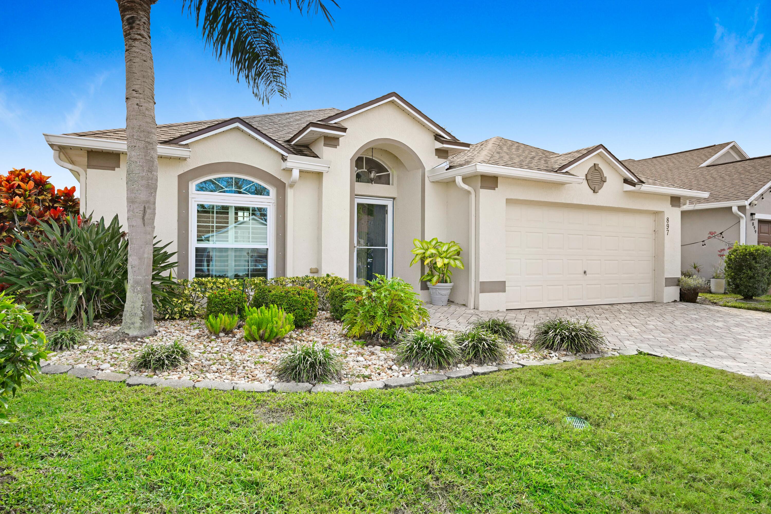 897 Shaw Circle Melbourne, FL 32940 - Photo 39 of 57 a front view of a house with a garden