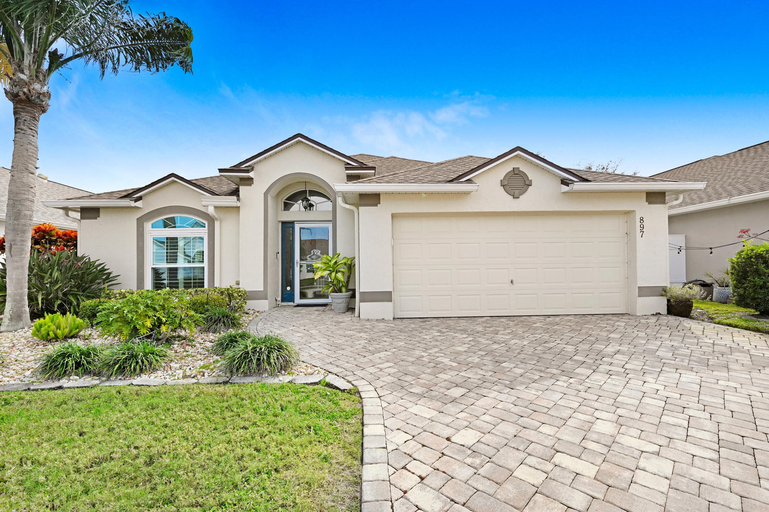 897 Shaw Circle Melbourne, FL 32940 - Photo 40 of 57 a front view of a house with a yard and garage