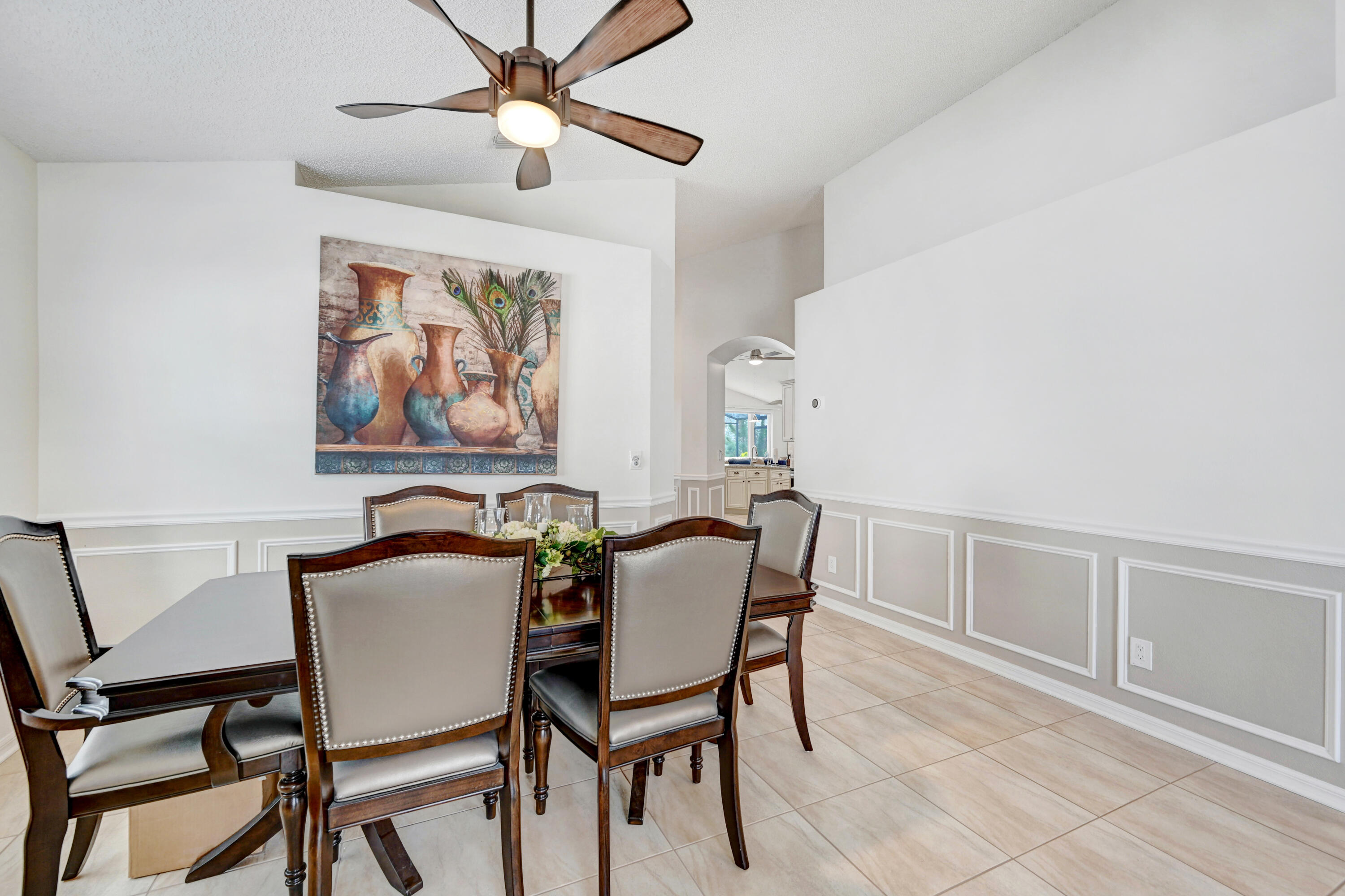 897 Shaw Circle Melbourne, FL 32940 - Photo 46 of 57 a view of a dining room with furniture and a chandelier fan