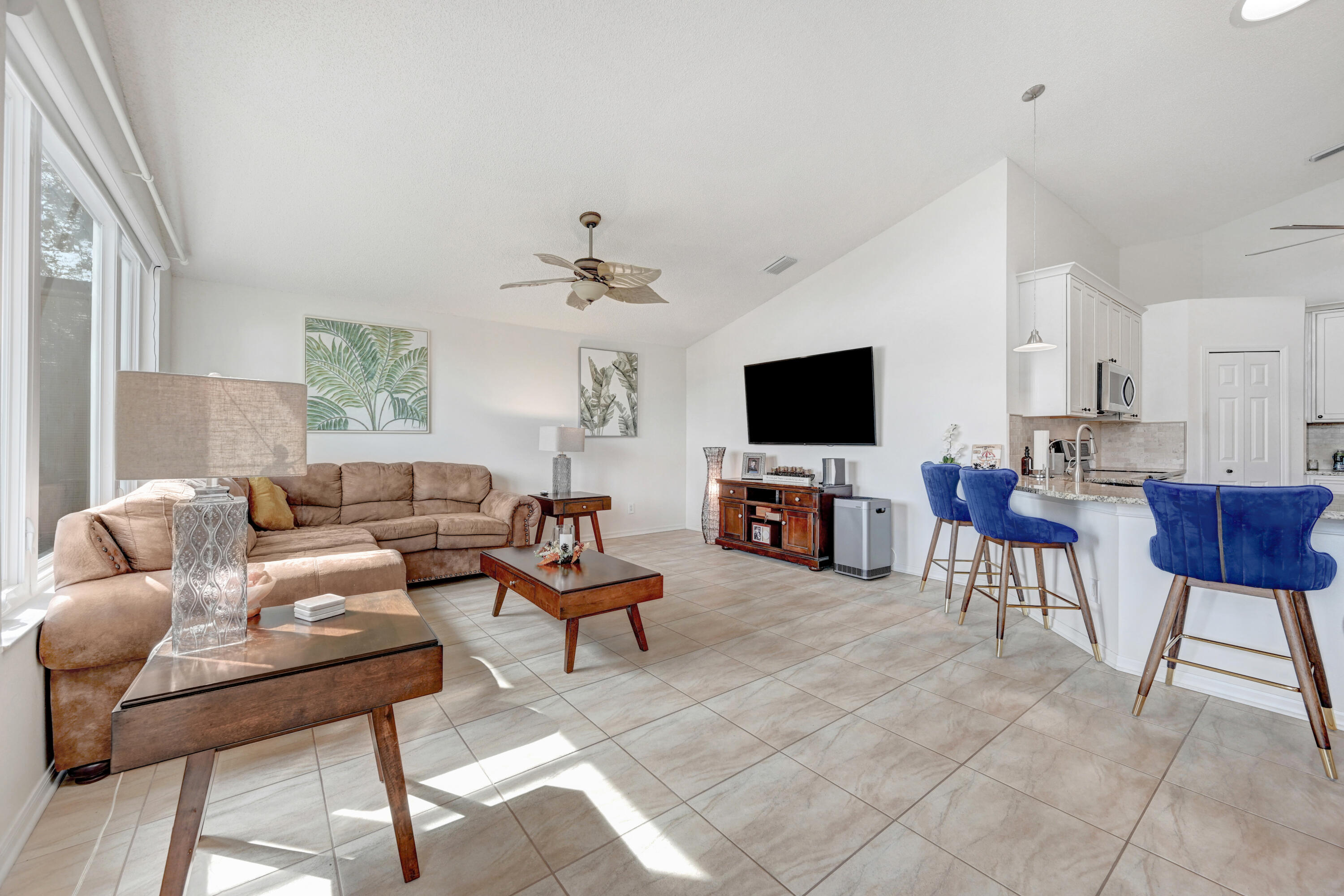 897 Shaw Circle Melbourne, FL 32940 - Photo 50 of 57 a living room with furniture and a flat screen tv