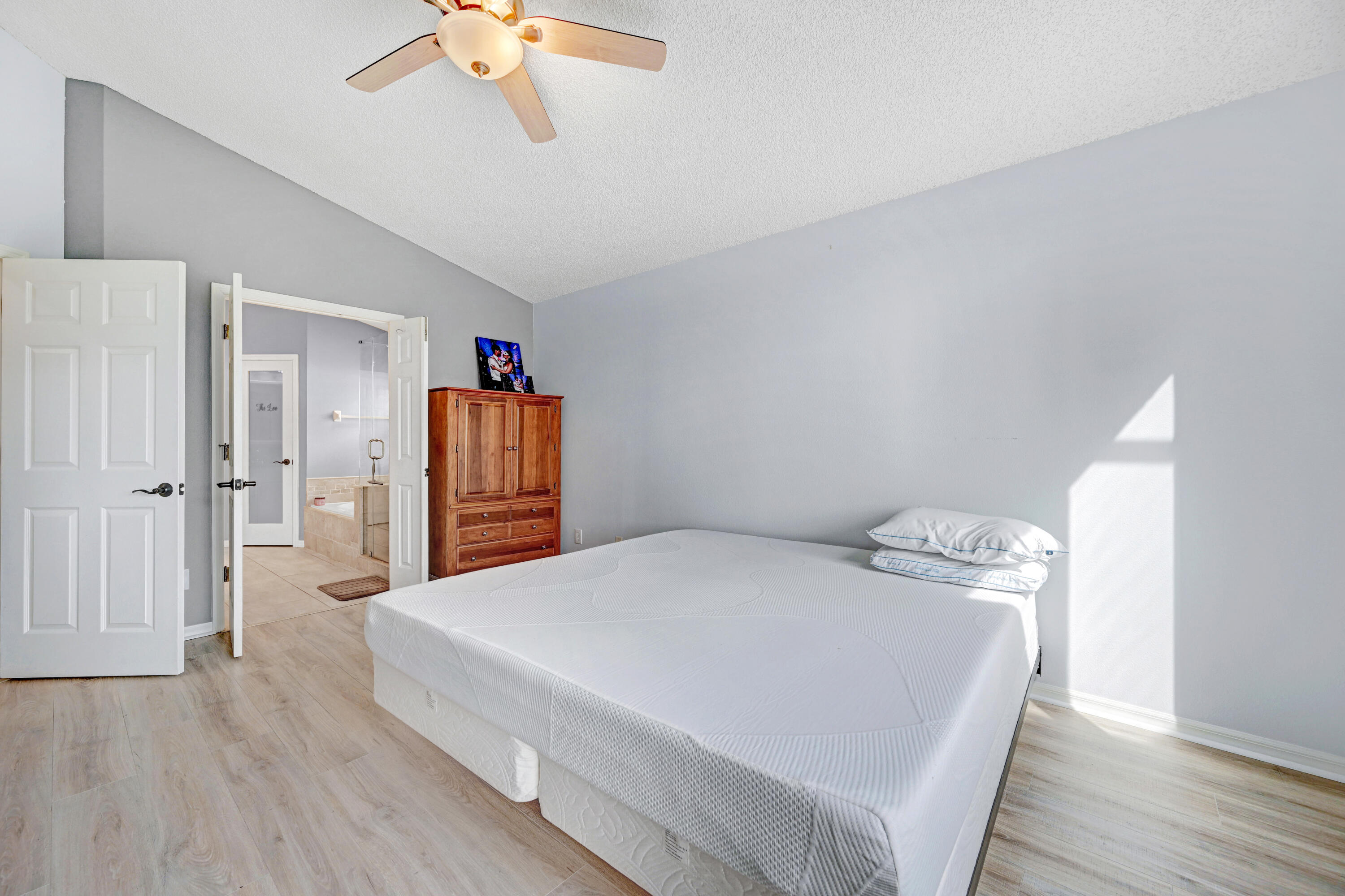 897 Shaw Circle Melbourne, FL 32940 - Photo 55 of 57 a bedroom with a bed and a chandelier