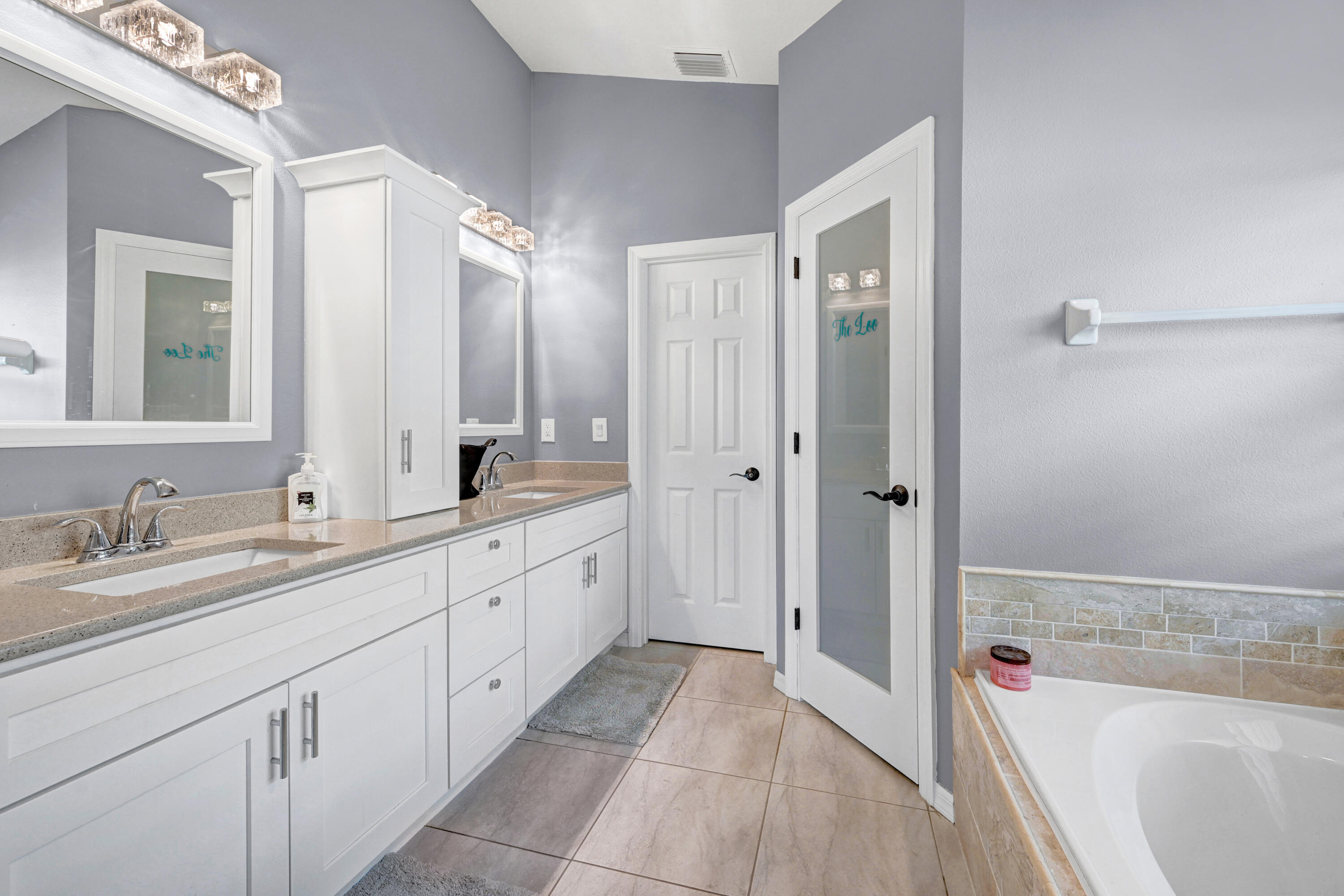 897 Shaw Circle Melbourne, FL 32940 - Photo 56 of 57 a spacious bathroom with a tub sink shower and mirror