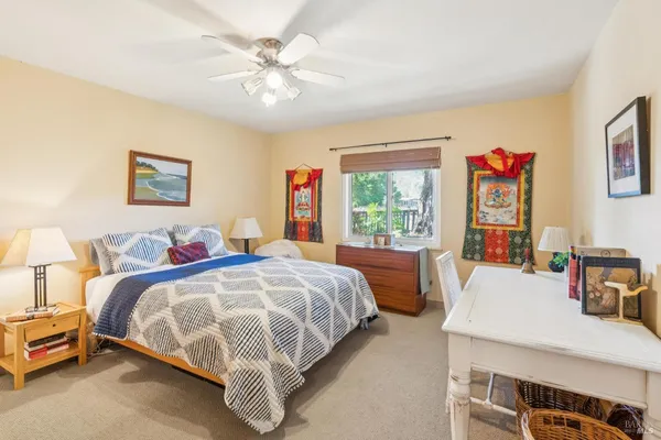 a bathroom with a painting on the wall