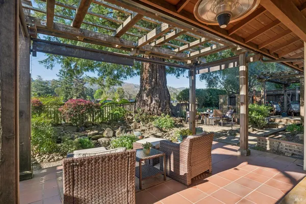 a view of a sitting area with furniture in backyard