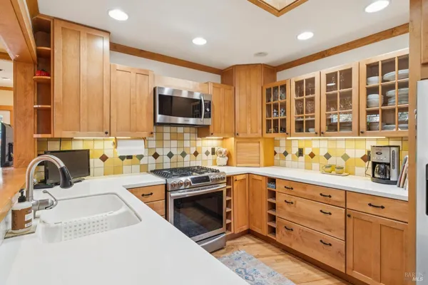 a kitchen with stainless steel appliances a refrigerator and a stove