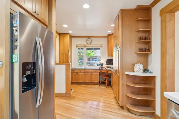 a kitchen with stainless steel appliances granite countertop a stove a sink and a refrigerator