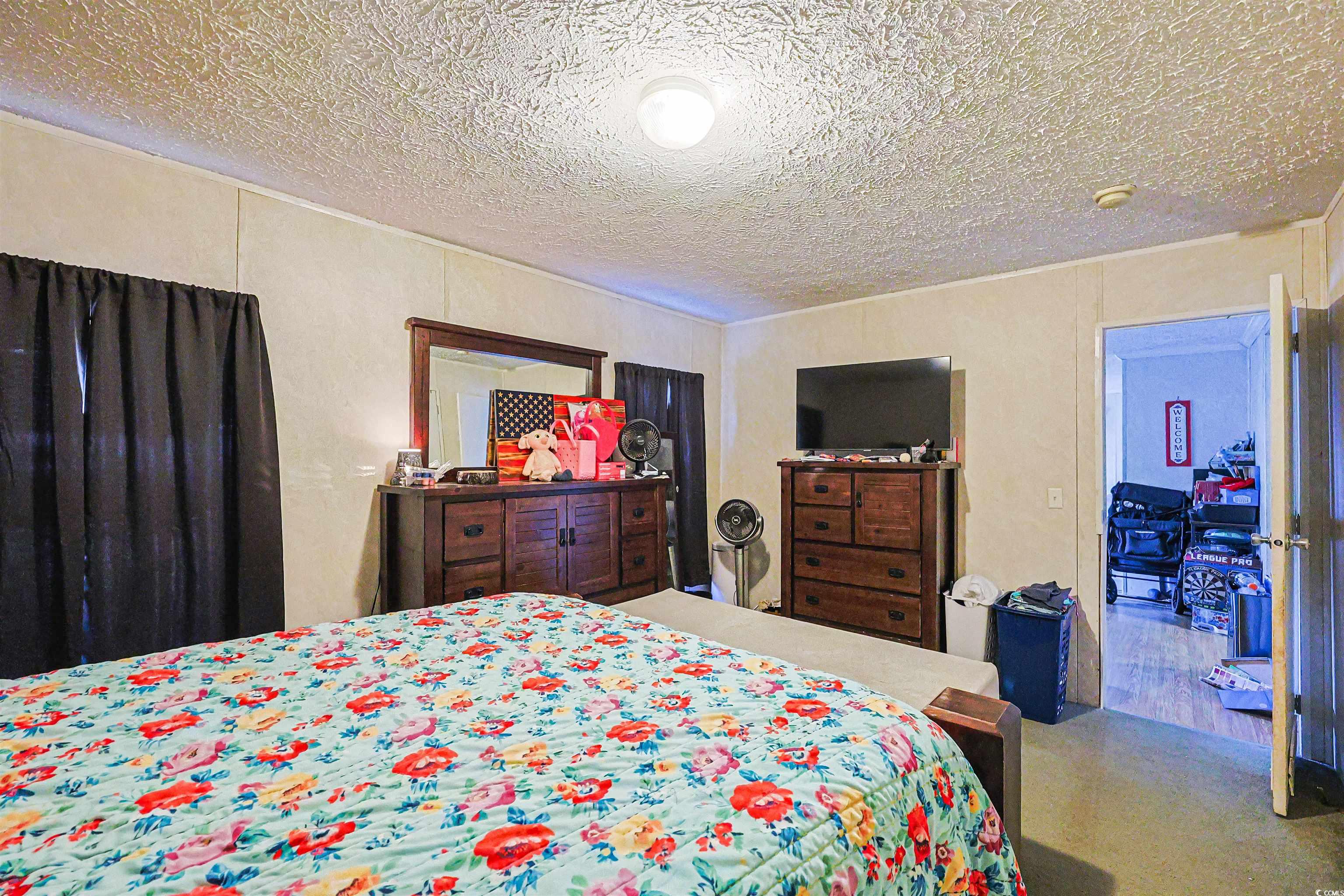 2128 Harvey Road Loris, SC 29569 - Photo 16 of 31 Carpeted bedroom with a textured ceiling
