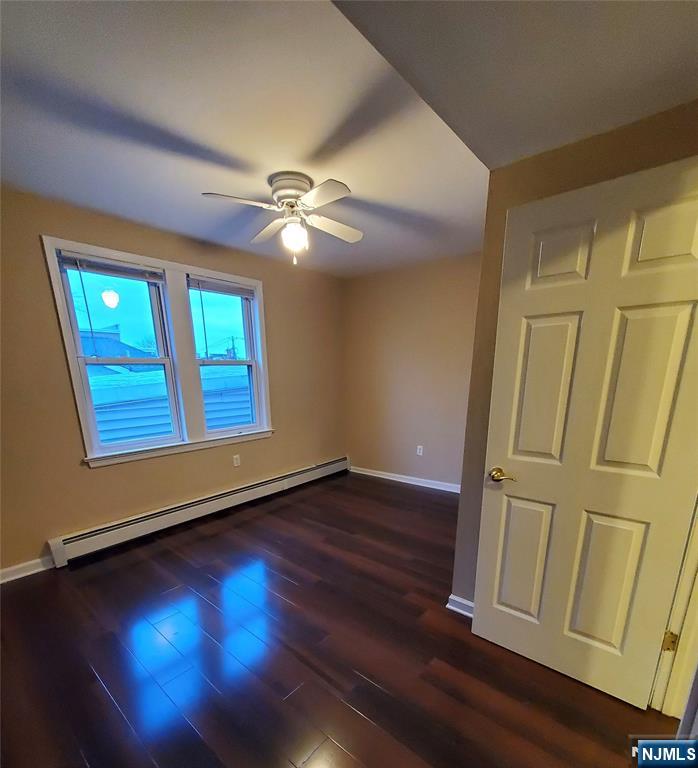 21 Columbus Street Bloomfield, NJ 07003 - Photo 5 of 20 an empty room with wooden floor fan and windows