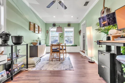 a kitchen with kitchen island white cabinets and stainless steel appliances