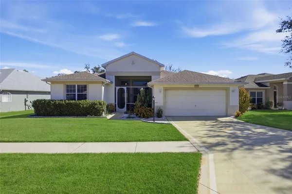 a front view of a house with a garden and yard