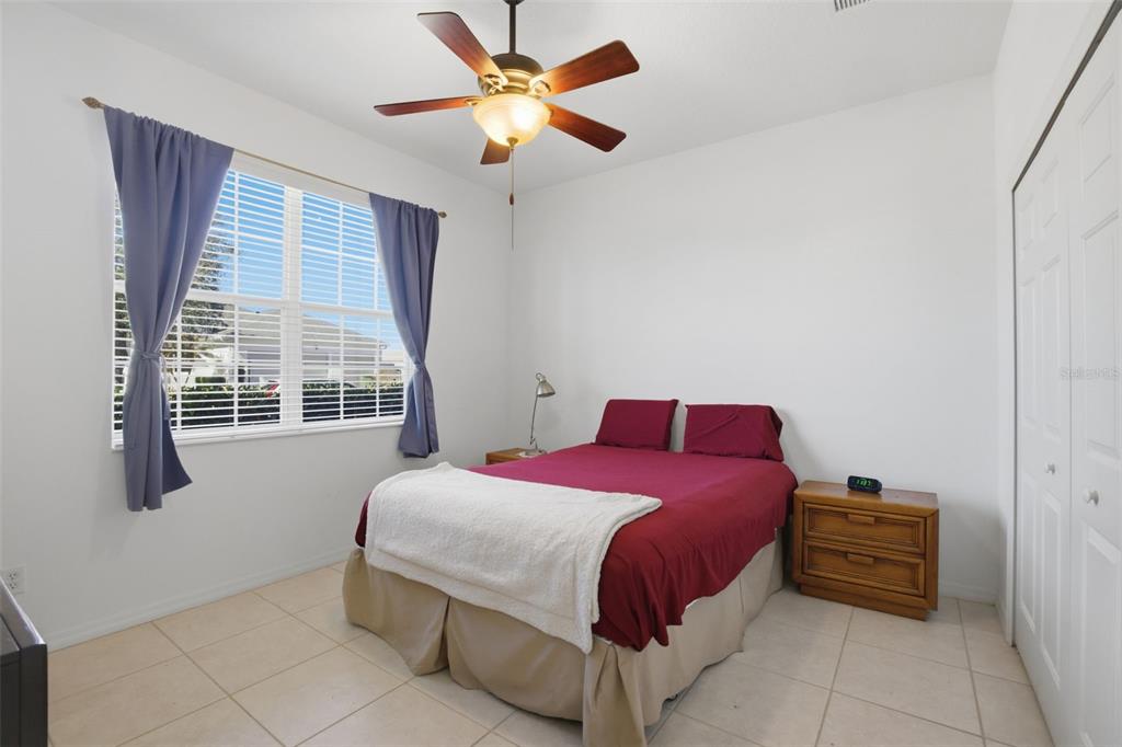 5922 Sage Leaf Place Leesburg, FL 34748 - Photo 19 of 39 a bedroom with a bed and a window