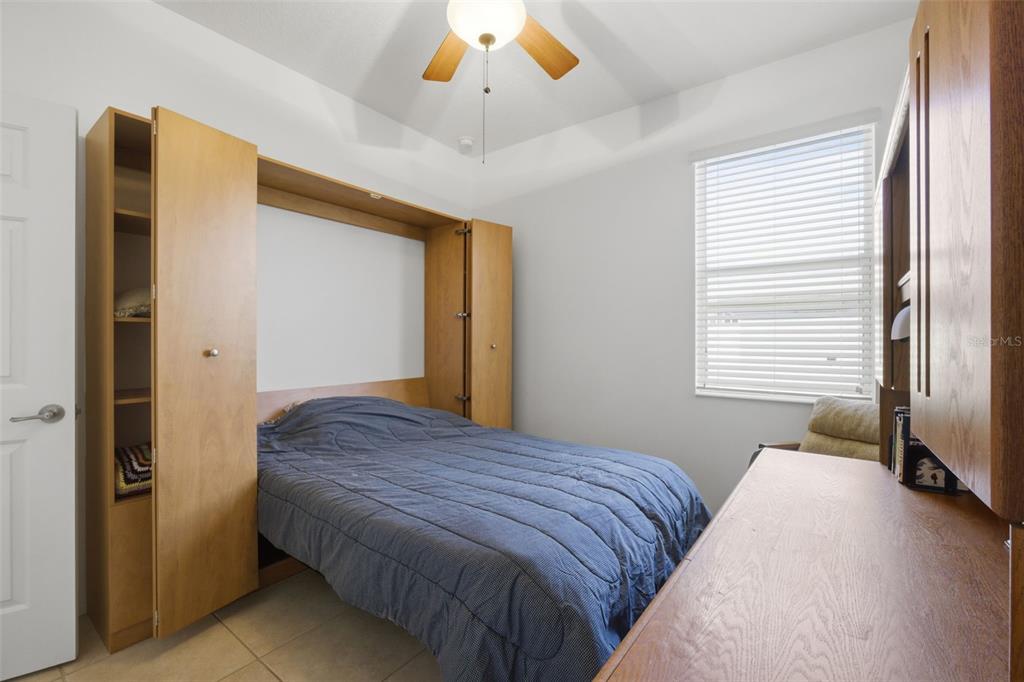 5922 Sage Leaf Place Leesburg, FL 34748 - Photo 24 of 39 a bedroom with a bed and a large window