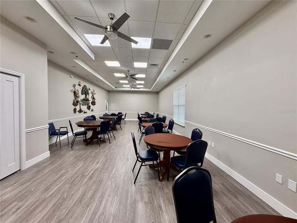 5922 Sage Leaf Place Leesburg, FL 34748 - Photo 34 of 39 a view of a room with furniture and chandelier
