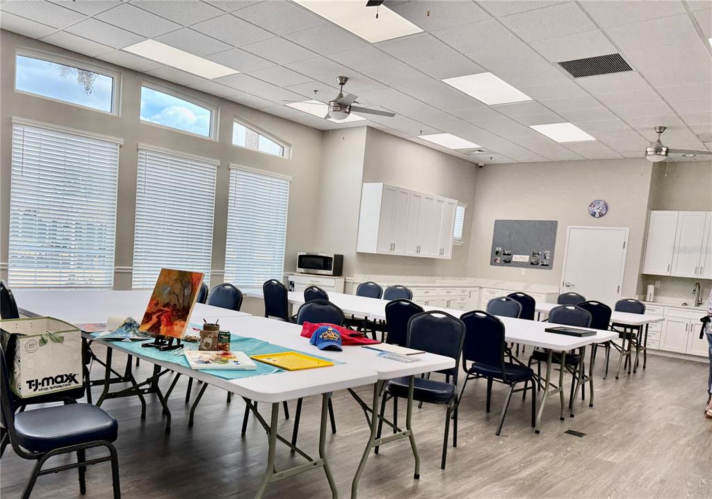5922 Sage Leaf Place Leesburg, FL 34748 - Photo 36 of 39 a view of a dining room with furniture window and wooden floor