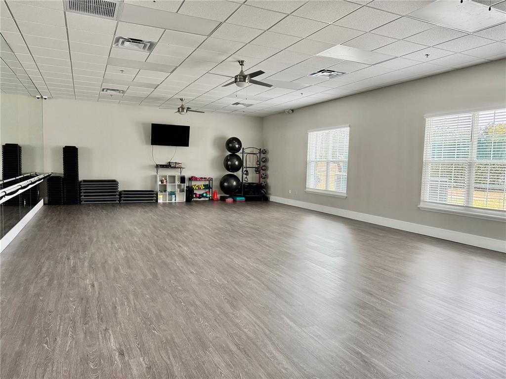 5922 Sage Leaf Place Leesburg, FL 34748 - Photo 37 of 39 a view of a livingroom with hardwood floor and a ceiling fan