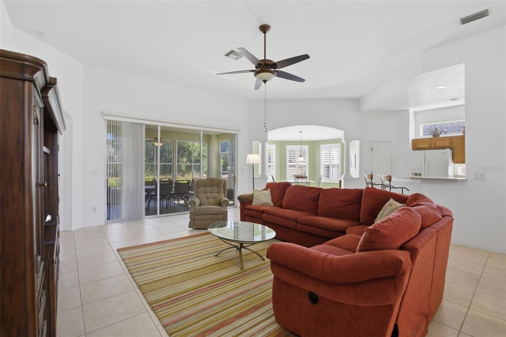 5922 Sage Leaf Place Leesburg, FL 34748 - Photo 5 of 39 a living room with furniture a chandelier and a window