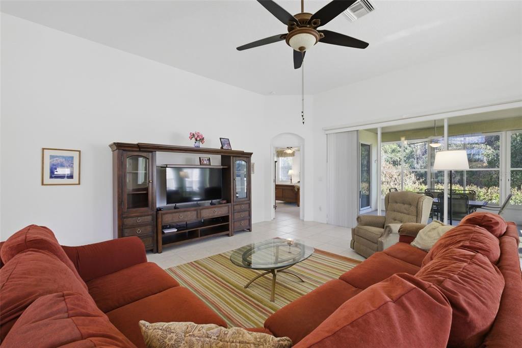 5922 Sage Leaf Place Leesburg, FL 34748 - Photo 6 of 39 a living room with furniture and a flat screen tv