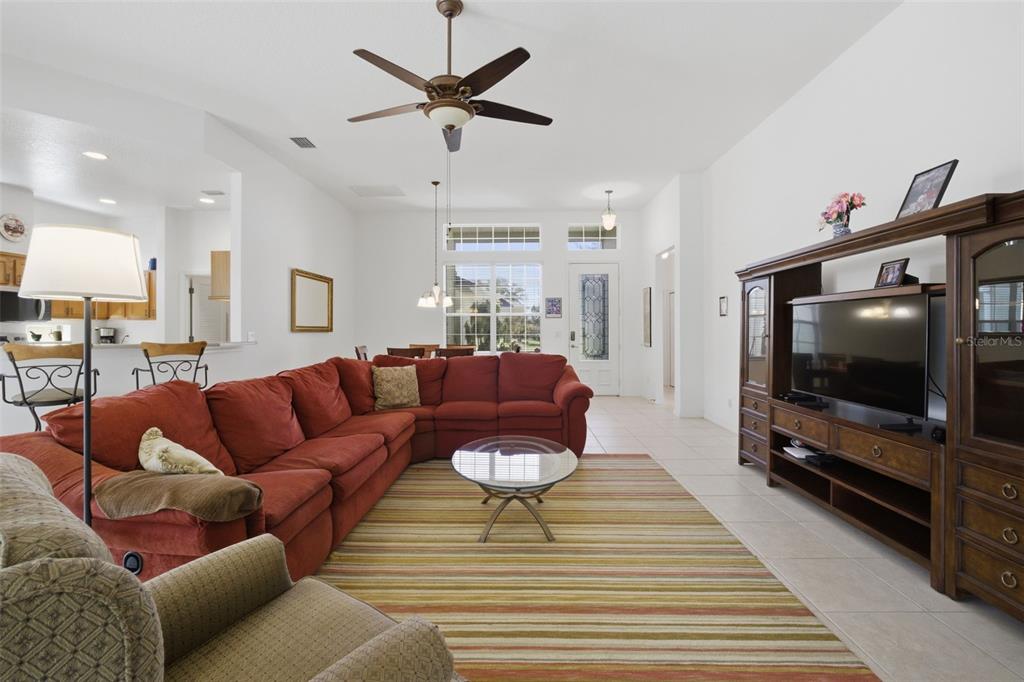 5922 Sage Leaf Place Leesburg, FL 34748 - Photo 7 of 39 a living room with furniture and a flat screen tv