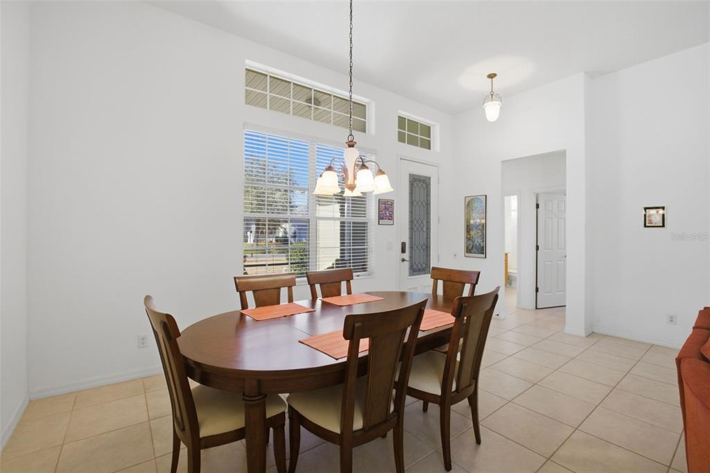 5922 Sage Leaf Place Leesburg, FL 34748 - Photo 9 of 39 a view of a dining room with furniture and chandelier