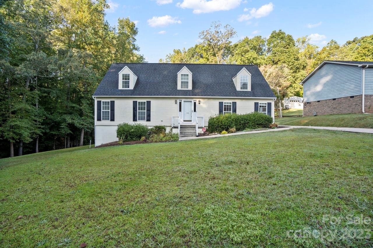 112 Walnut Street Lowell, NC 28098 - Photo 1 of 27 a front view of house with yard and green space