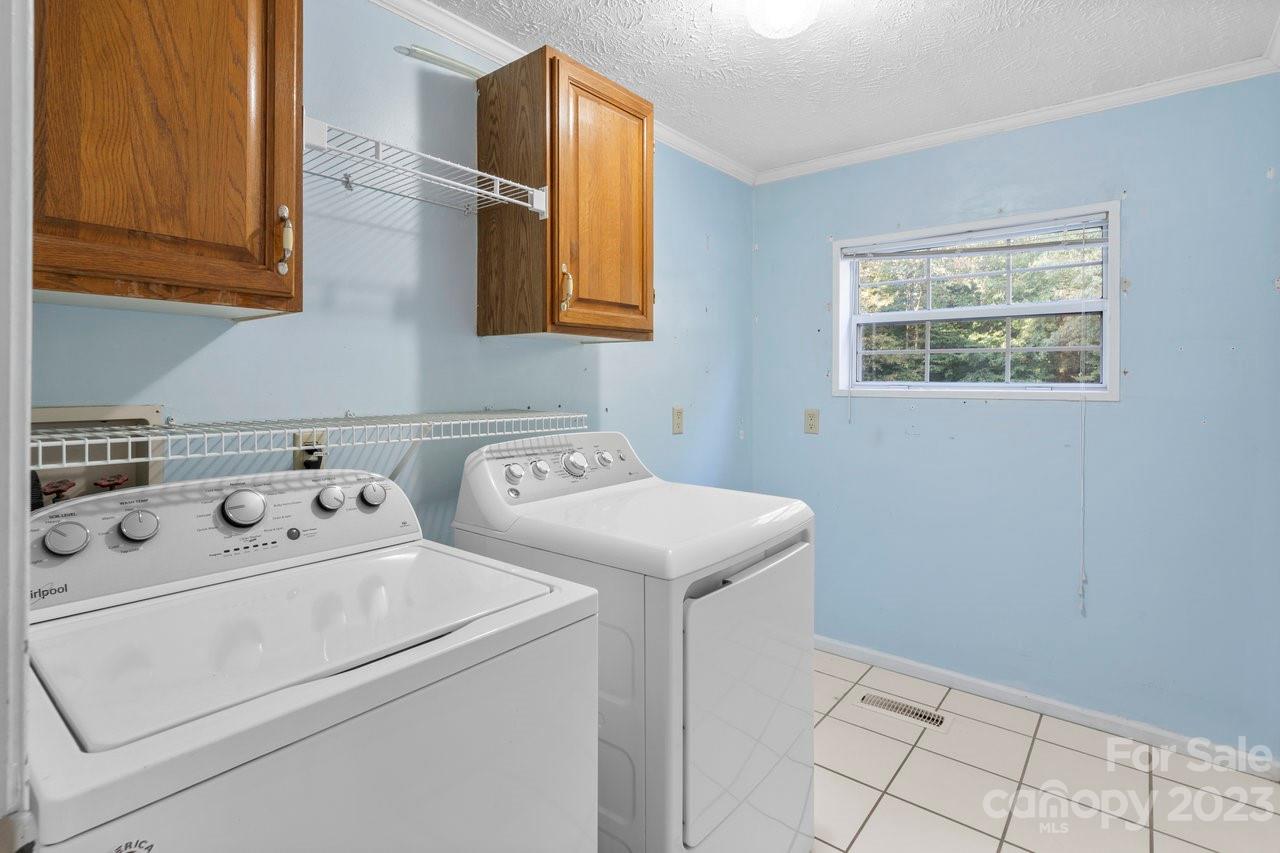 112 Walnut Street Lowell, NC 28098 - Photo 12 of 27 a utility room with dryer and washer