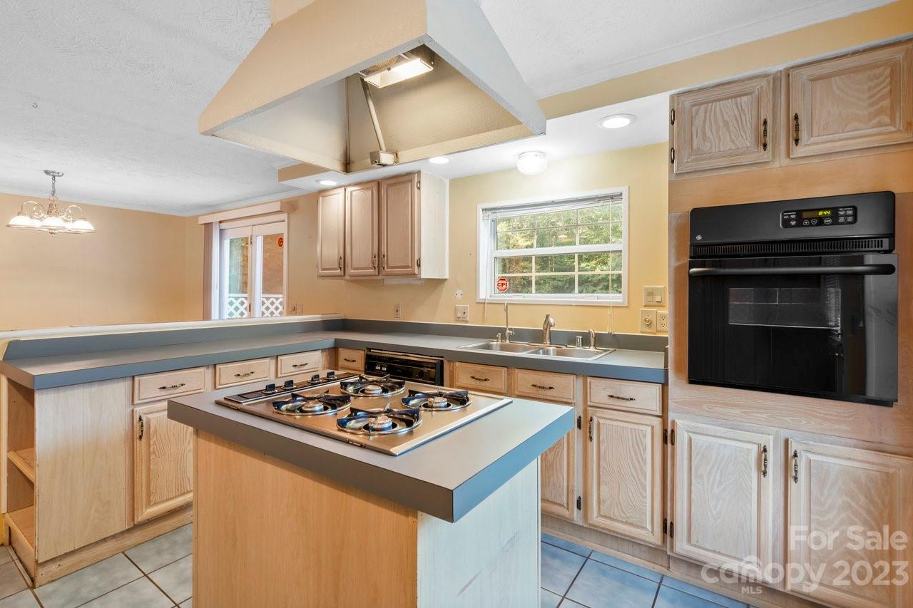 112 Walnut Street Lowell, NC 28098 - Photo 15 of 27 a kitchen with granite countertop a stove sink and microwave