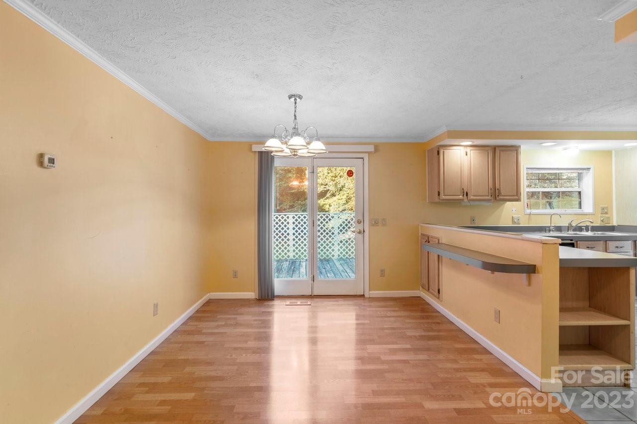 112 Walnut Street Lowell, NC 28098 - Photo 17 of 27 a view of a kitchen with a sink and dishwasher with wooden floor