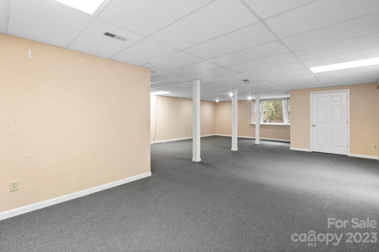 112 Walnut Street Lowell, NC 28098 - Photo 4 of 27 an empty room with a empty space and windows