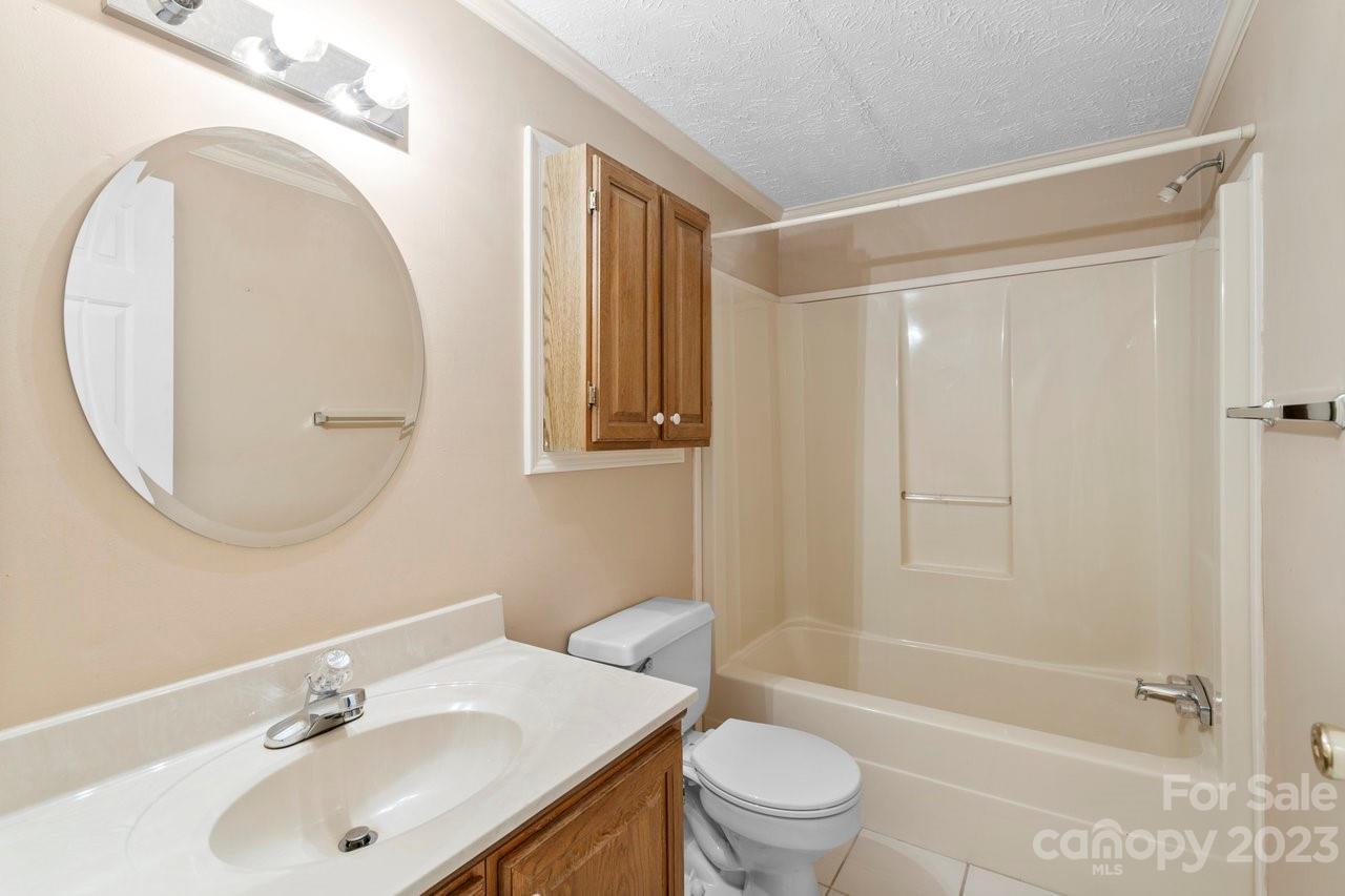 112 Walnut Street Lowell, NC 28098 - Photo 6 of 27 a bathroom with a sink toilet and shower