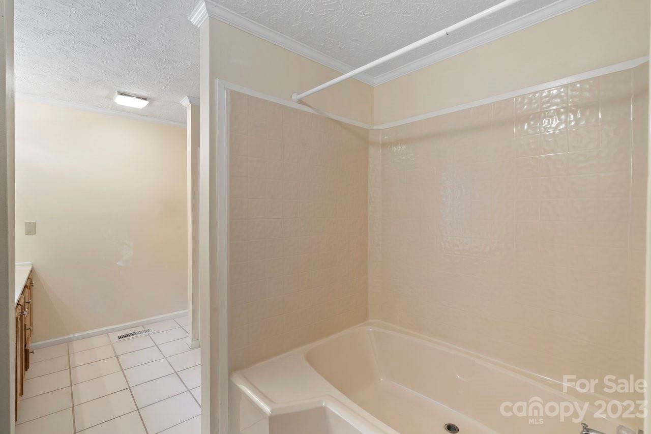 112 Walnut Street Lowell, NC 28098 - Photo 8 of 27 a bathroom with a bathtub