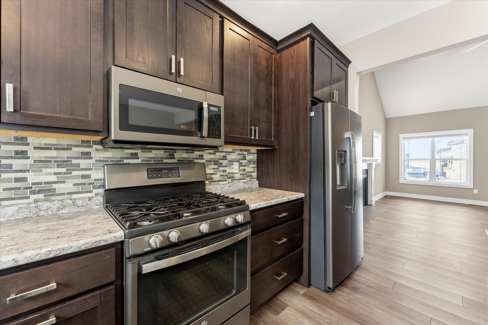 3411 Boulder Ridge Drive Champaign, IL 61822 - Photo 14 of 36 a kitchen with wooden cabinets and a stove top oven