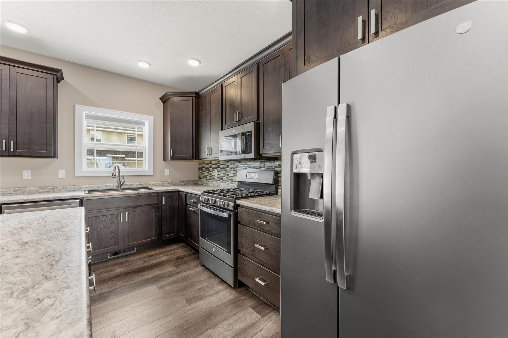 3411 Boulder Ridge Drive Champaign, IL 61822 - Photo 15 of 36 a kitchen with stainless steel appliances granite countertop a refrigerator and a stove top oven