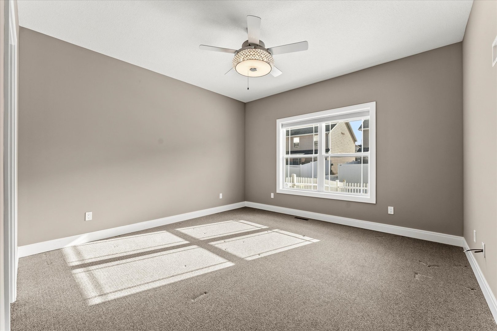 3411 Boulder Ridge Drive Champaign, IL 61822 - Photo 19 of 36 an empty room with windows and ceiling fan