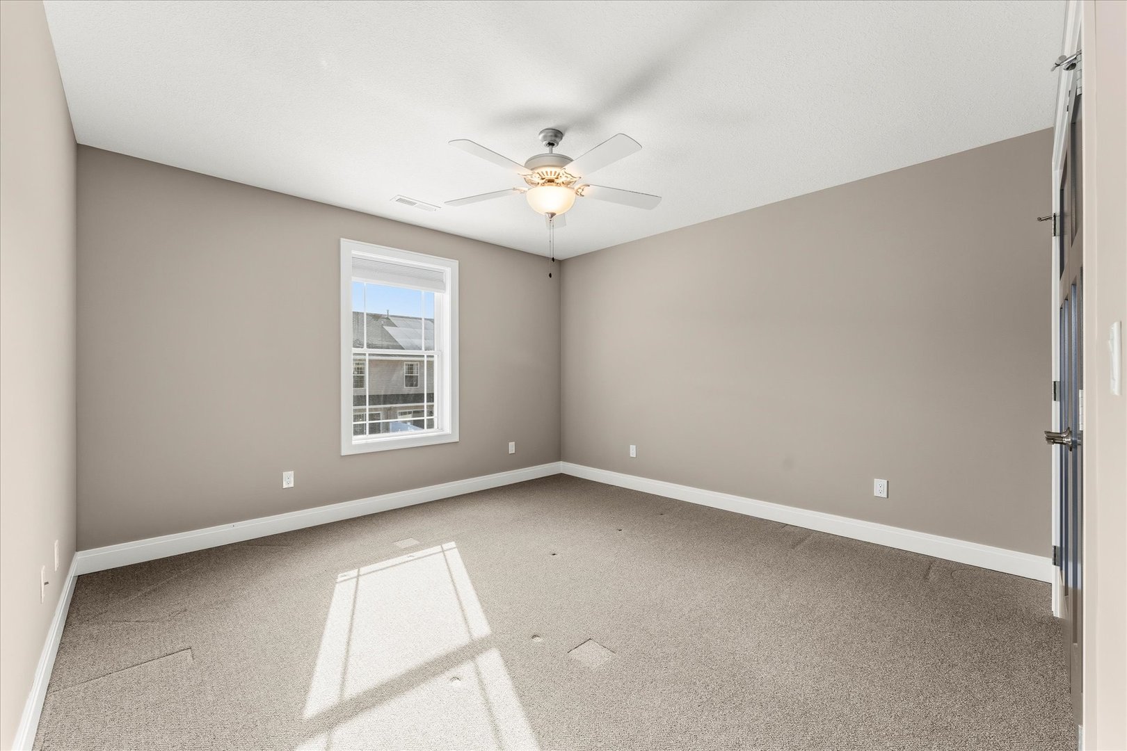 3411 Boulder Ridge Drive Champaign, IL 61822 - Photo 23 of 36 an empty room with windows and fan