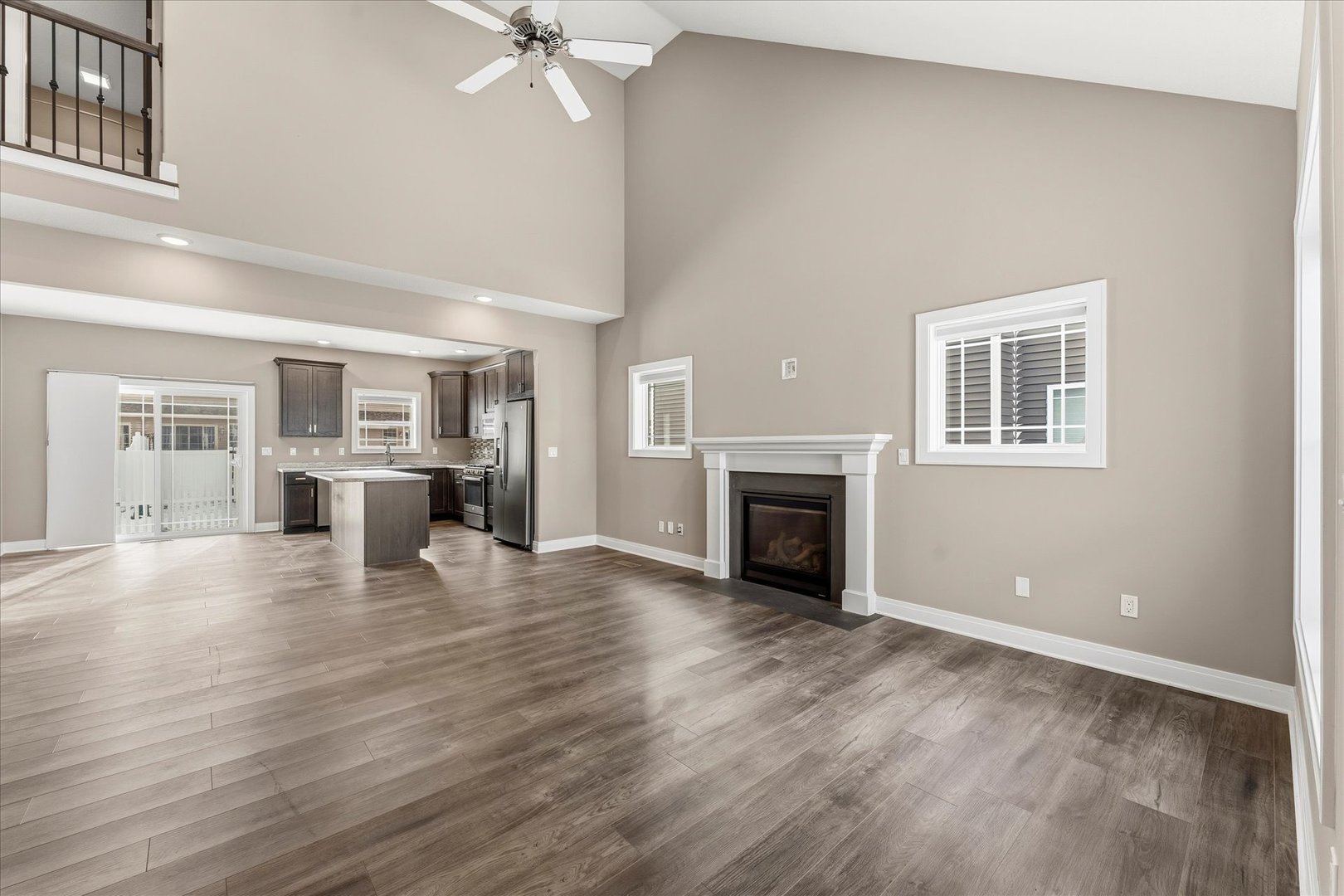 3411 Boulder Ridge Drive Champaign, IL 61822 - Photo 4 of 36 an empty room with wooden floor fireplace and windows