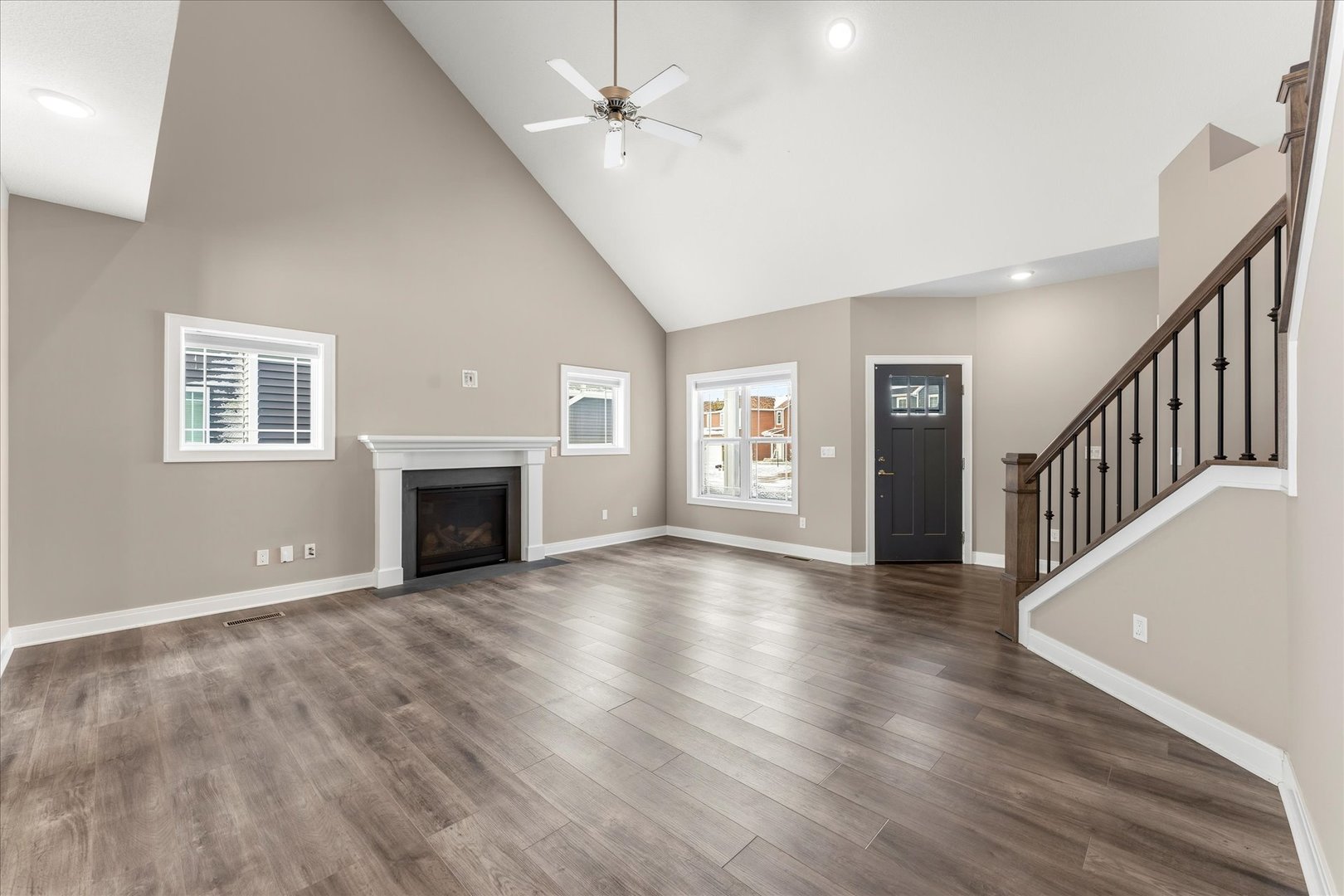 3411 Boulder Ridge Drive Champaign, IL 61822 - Photo 7 of 36 wooden floor fireplace and windows in an empty room