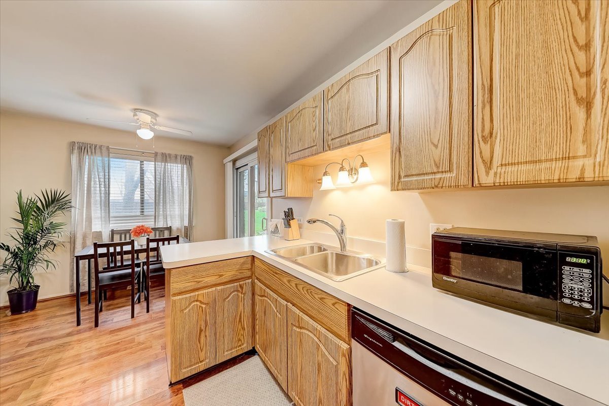 1110 Scanlon Drive, Unit D1 Wheeling, IL 60090 - Photo 11 of 23 a kitchen with stainless steel appliances white cabinets and a stove top oven
