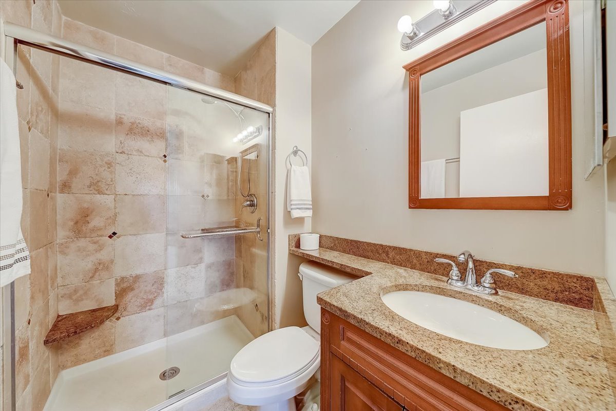 1110 Scanlon Drive, Unit D1 Wheeling, IL 60090 - Photo 15 of 23 a bathroom with a granite countertop sink toilet and shower