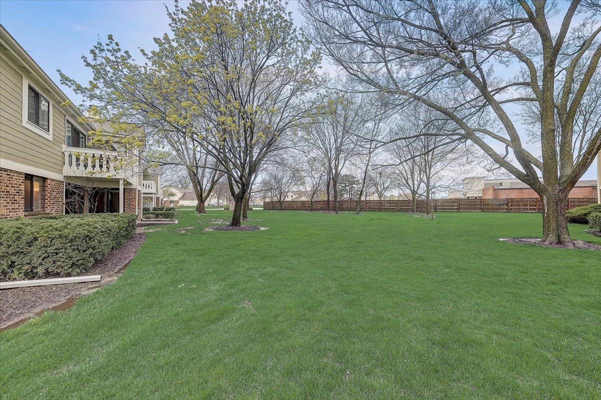 1110 Scanlon Drive, Unit D1 Wheeling, IL 60090 - Photo 22 of 23 a view of house with a big yard