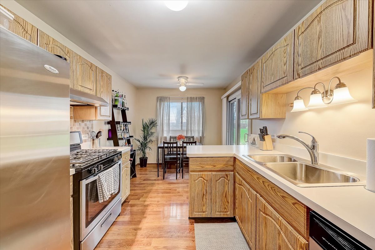 1110 Scanlon Drive, Unit D1 Wheeling, IL 60090 - Photo 10 of 23 a kitchen with a sink stove top oven and cabinets