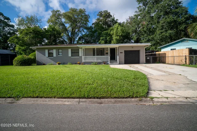 a front view of house with yard and green space