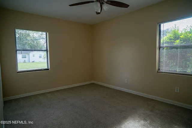 a view of a small space with wooden floor and a window