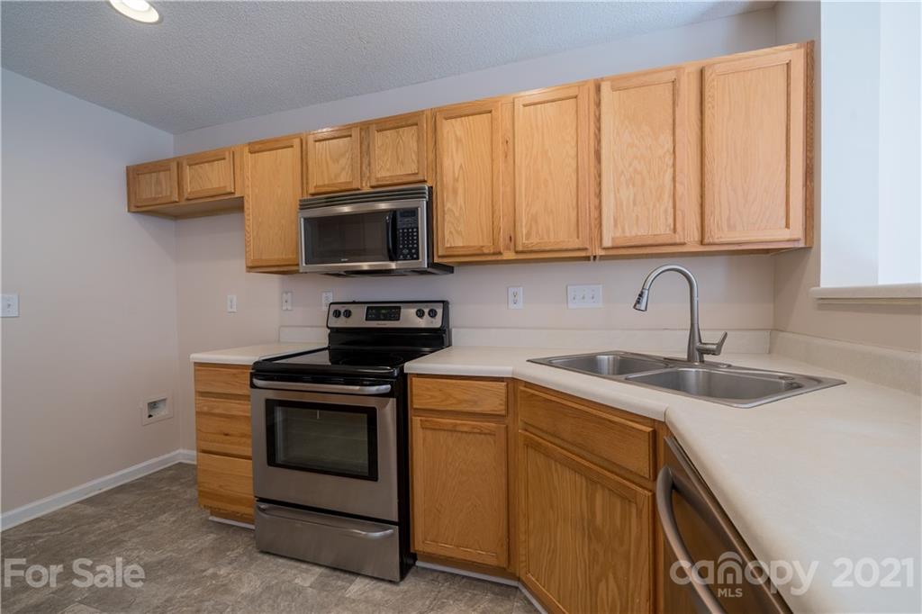 11329 Stone Trail Road Charlotte, NC 28213 - Photo 11 of 23 a kitchen with a sink stove and microwave
