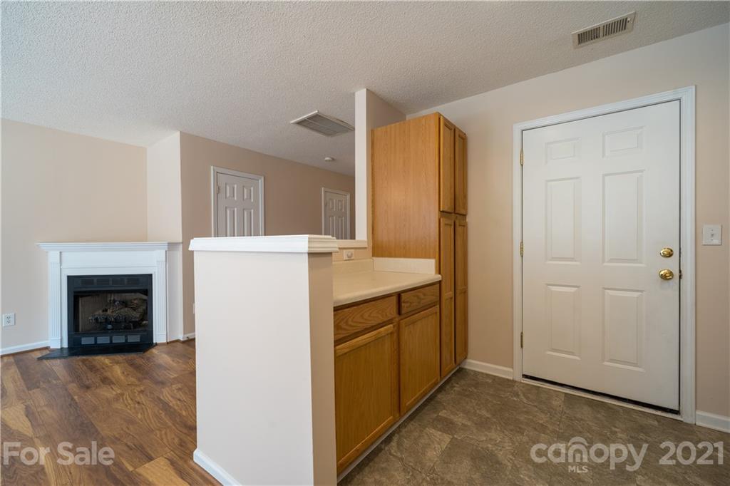 11329 Stone Trail Road Charlotte, NC 28213 - Photo 12 of 23 a view of a kitchen with refrigerator and a fireplace