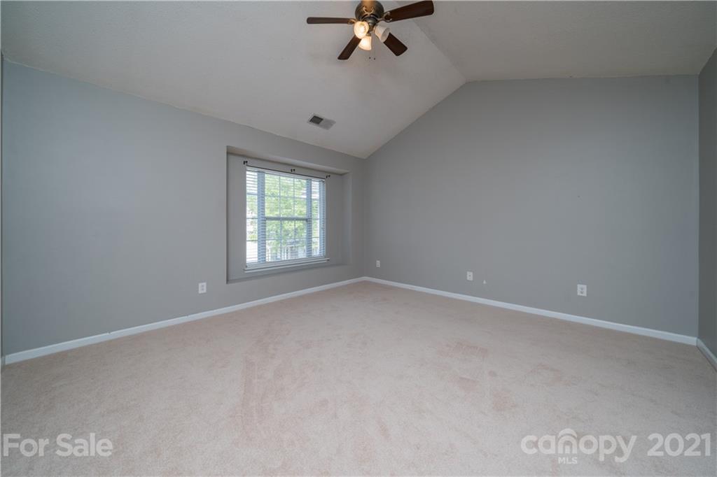11329 Stone Trail Road Charlotte, NC 28213 - Photo 15 of 23 an empty room with a ceiling fan and window