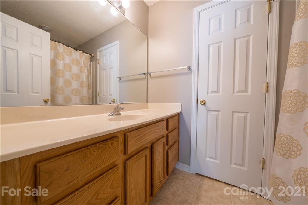 11329 Stone Trail Road Charlotte, NC 28213 - Photo 16 of 23 a bathroom with a sink and a mirror