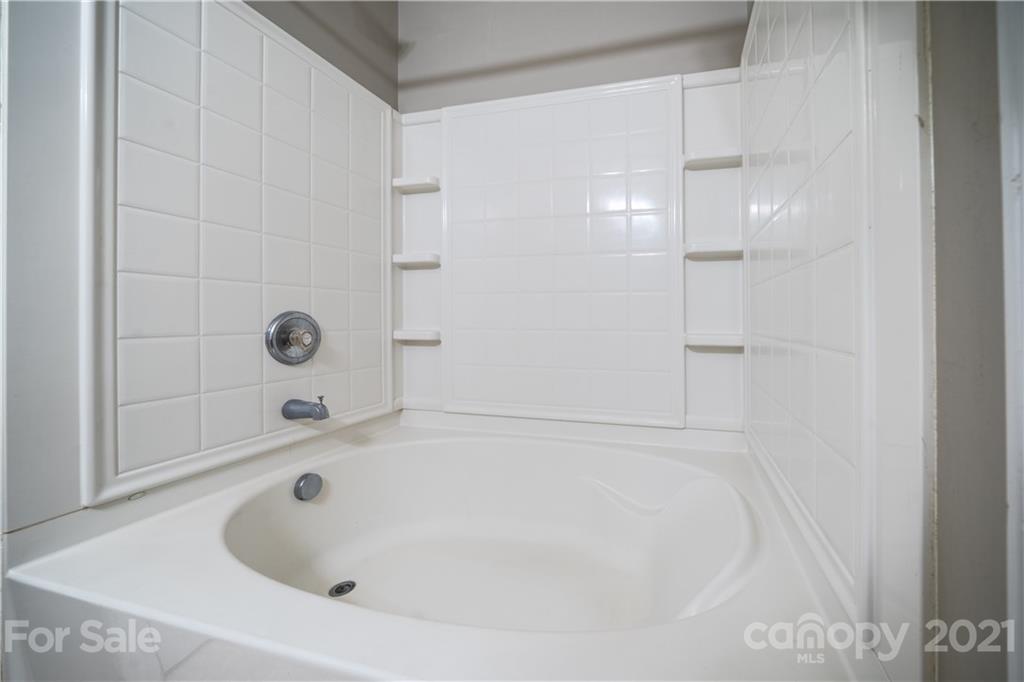 11329 Stone Trail Road Charlotte, NC 28213 - Photo 17 of 23 a bathroom with a tub and shower